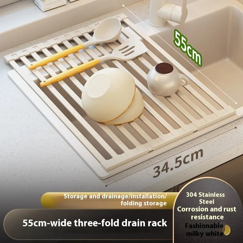 A milky white foldable stainless steel kitchen draining rack shown open on a countertop next to a sink.