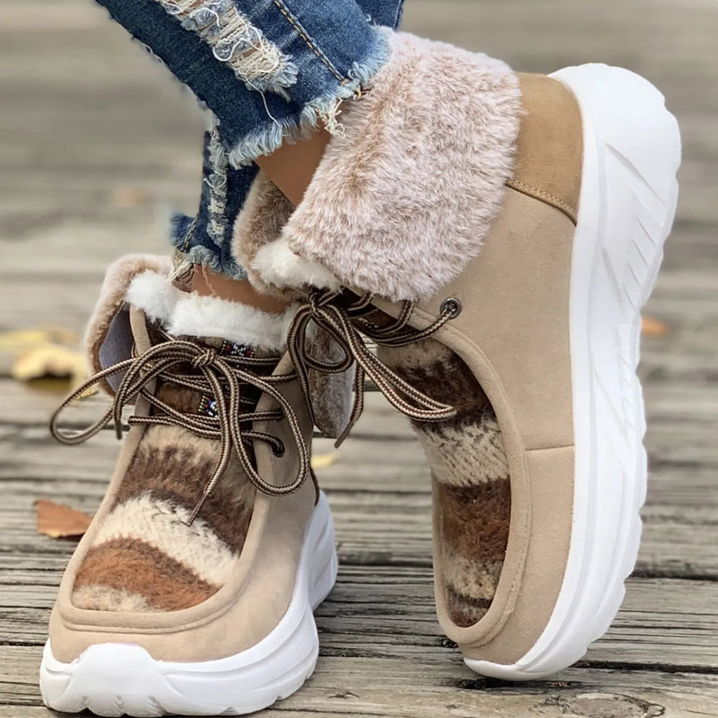 Women's beige lace-up snow boots with suede upper, thick rubber sole, and decorative stitching