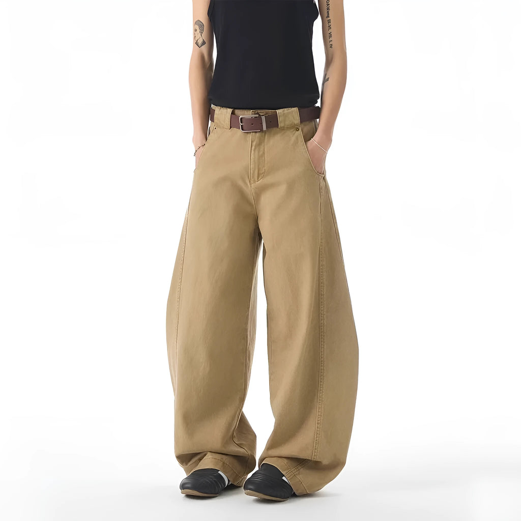 Brown loose-fit men's denim jeans with a straight leg and button fly on a neutral background.