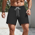Men's loose fit track shorts in straight-leg sports style available in multiple solid colours