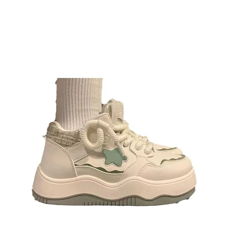 Green women's platform sneakers with patent leather finish, round toe, and white rubber sole.