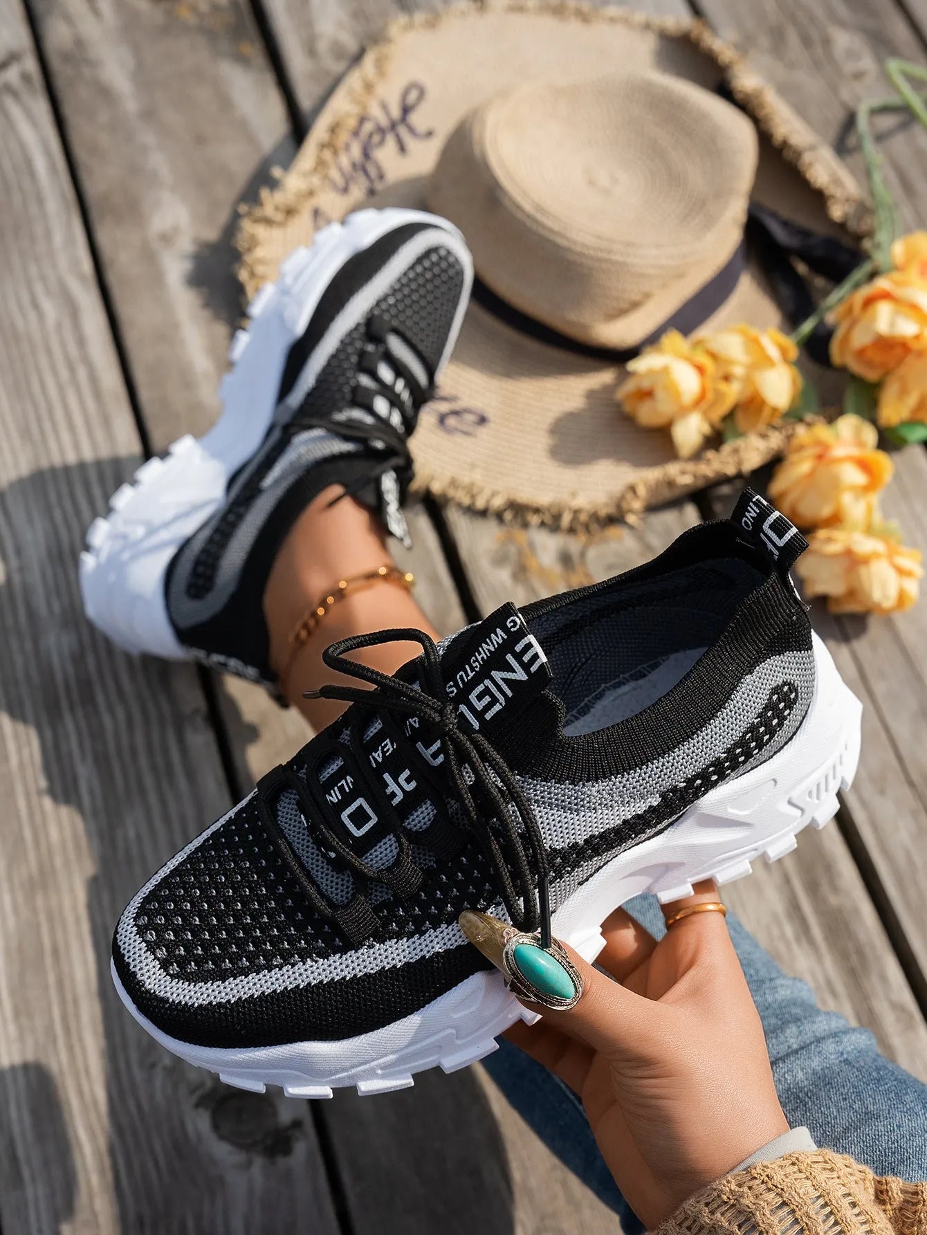 Women's Flyknit mesh lace-up sneaker in a grey colourway, showing the breathable upper and rubber sole.