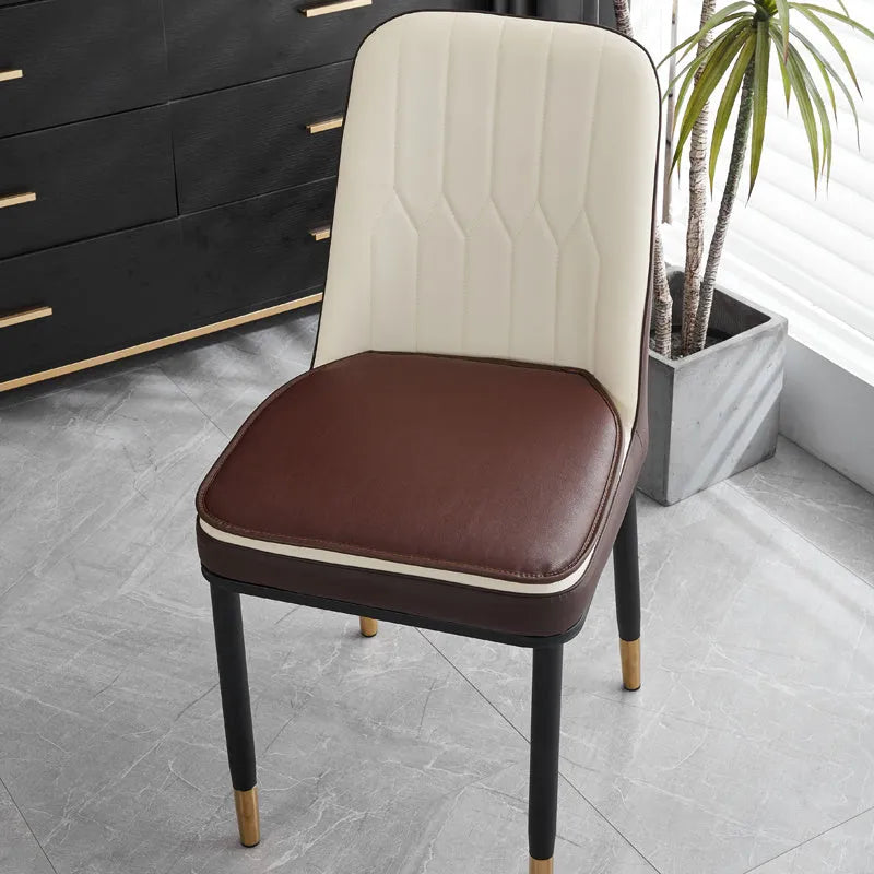 Brown leather horseshoe-shaped seat cushion with non-slip backing on a wooden chair.