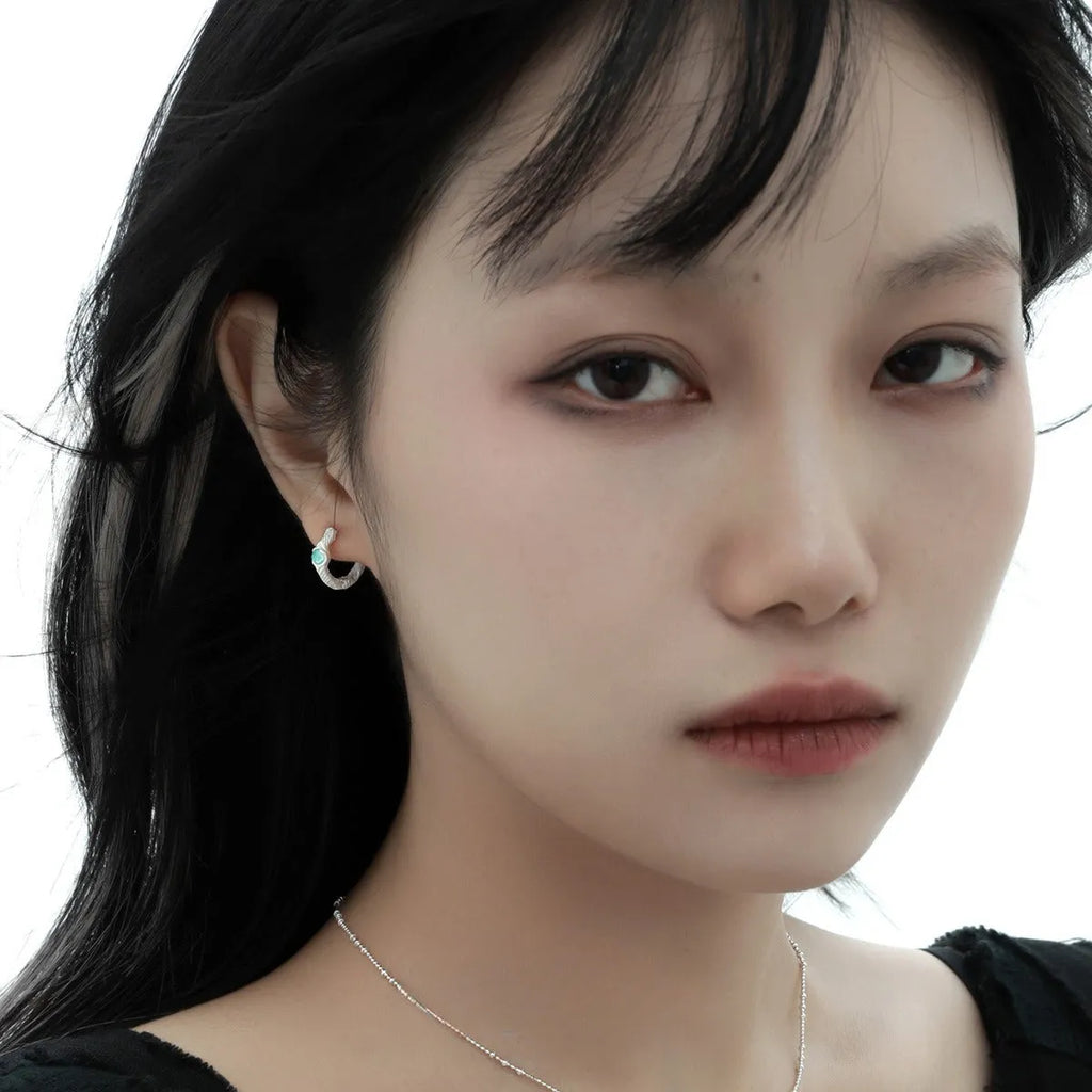 Geometric round ear clip in burnt silver tone, made from 925 silver with a clip-on back.