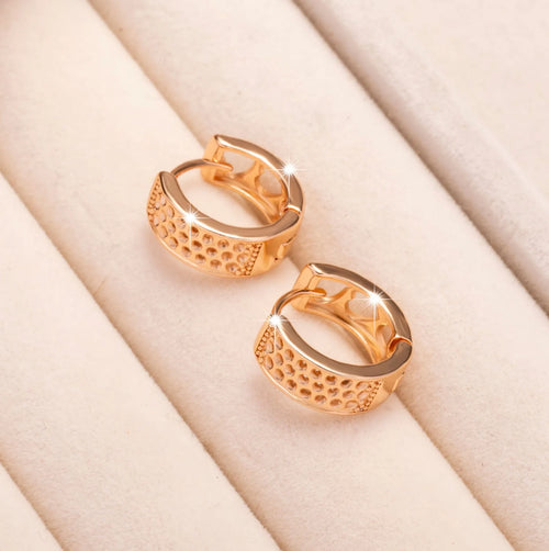 Circular rose gold earrings with three cut-out heart shapes