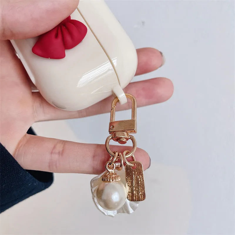 Beige and red bow shell design TPU silicone protective case for AirPods Pro charging case.