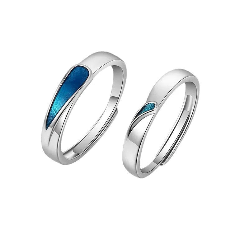 Blue tear drop copper ring with water drop shape and glue-drip finish on a dark background