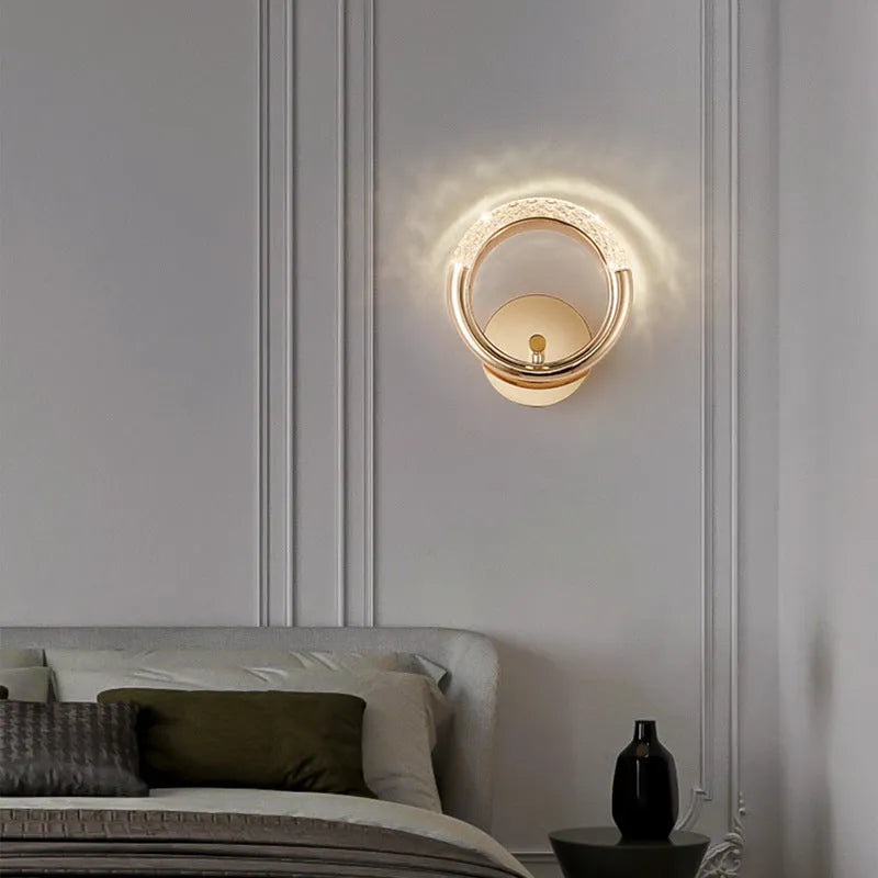 Modern minimalist bedroom wall lamp with a white acrylic shade on a wall.