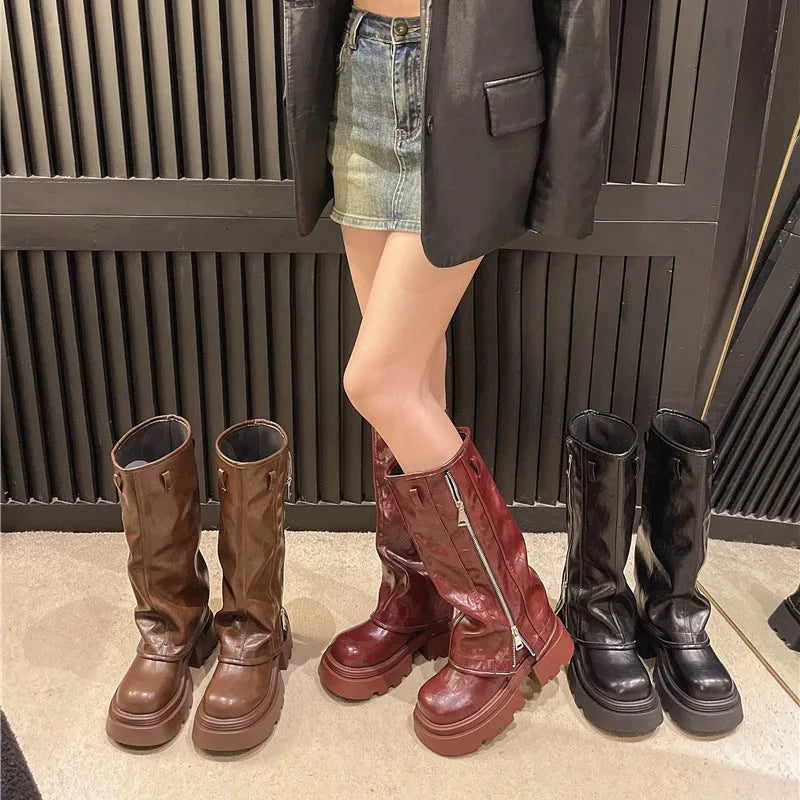 Black platform muffin pants Martin boots with high-cut sock and square rubber heel.