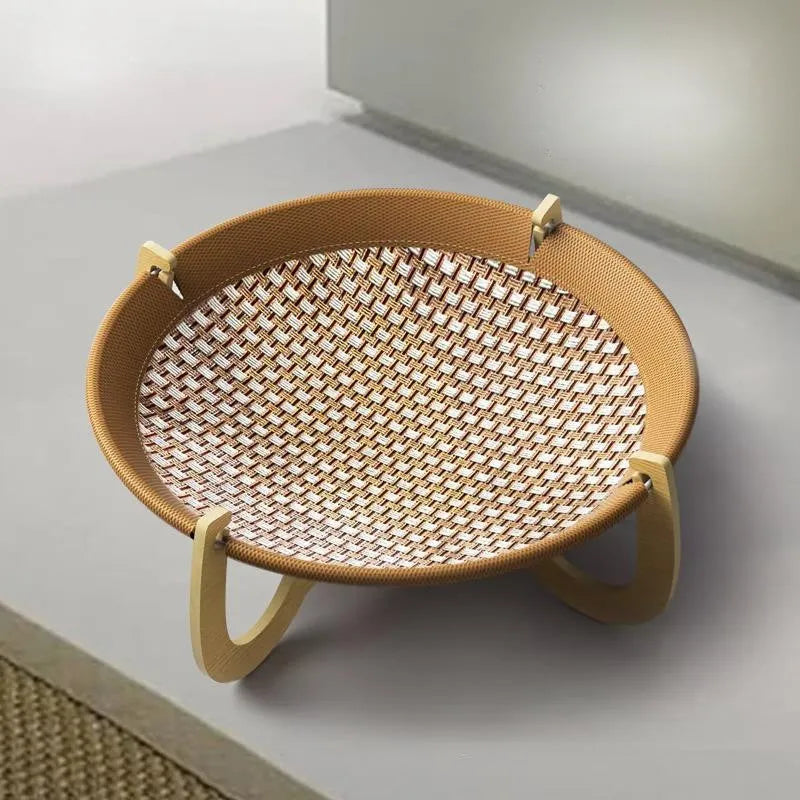 Brown square woven rattan pet hammock bed for cats and small dogs on a wooden floor.