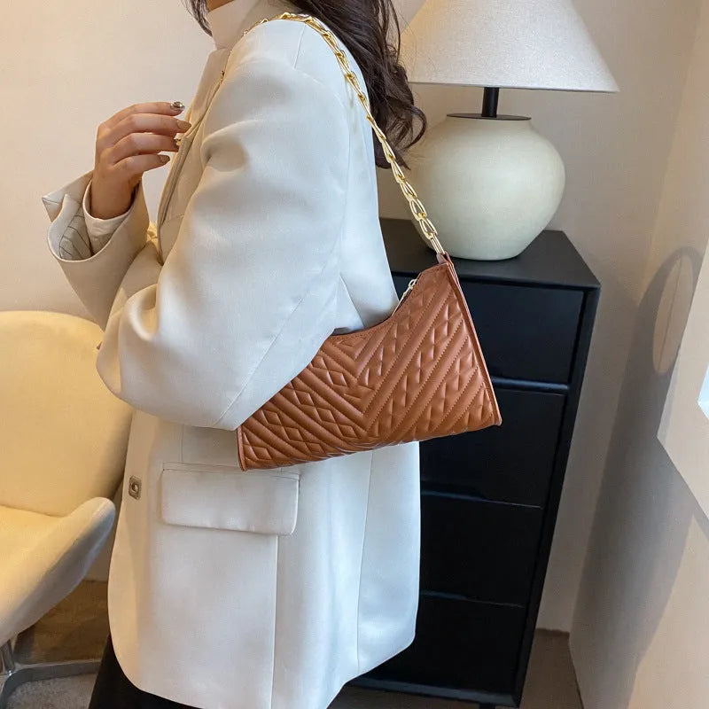 Brown pleated chain shoulder bag showing vertical square shape and adjustable strap
