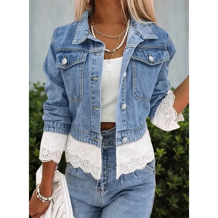 Blue denim jacket for women with lace stitching on the sleeves and front, shown on a hanger.