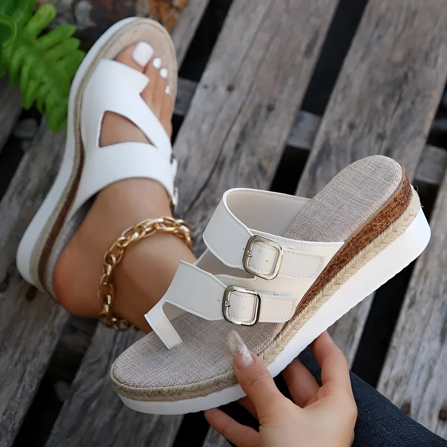 White patent leather woven wedge sandals with a peep toe and finger fit design on a neutral background.