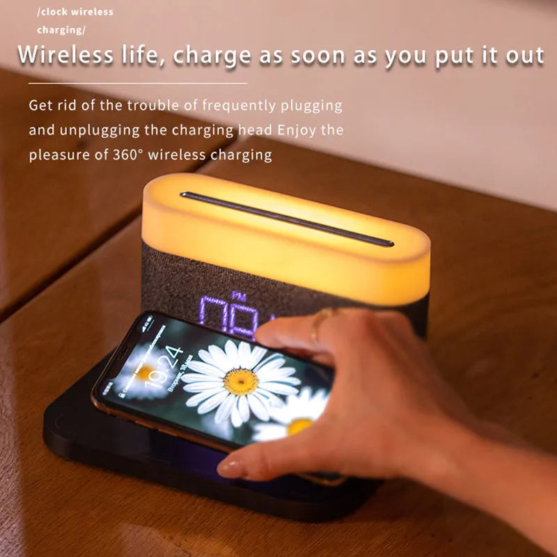 Black wireless charging desk clock with LED display and night light on wooden surface