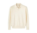 Man wearing a milky white pure wool polo sweater with a lapel collar and loose long sleeves.