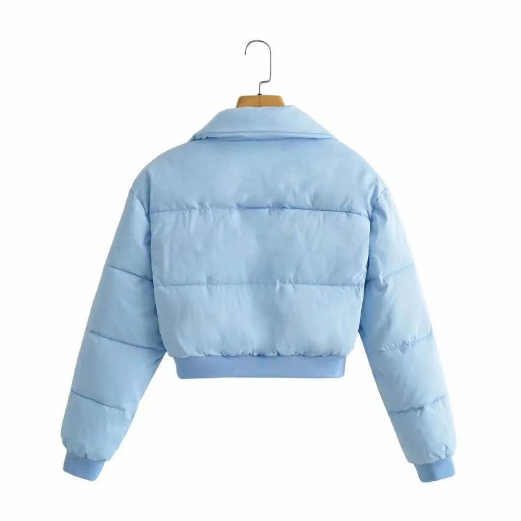 Blue loose fit polyester jacket for women with long sleeves on a hanger.