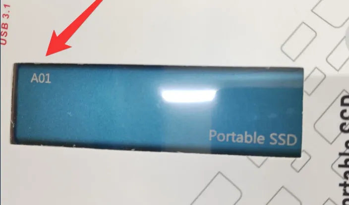 Red ultra-thin metal external SSD hard drive with high storage capacity on a desk.