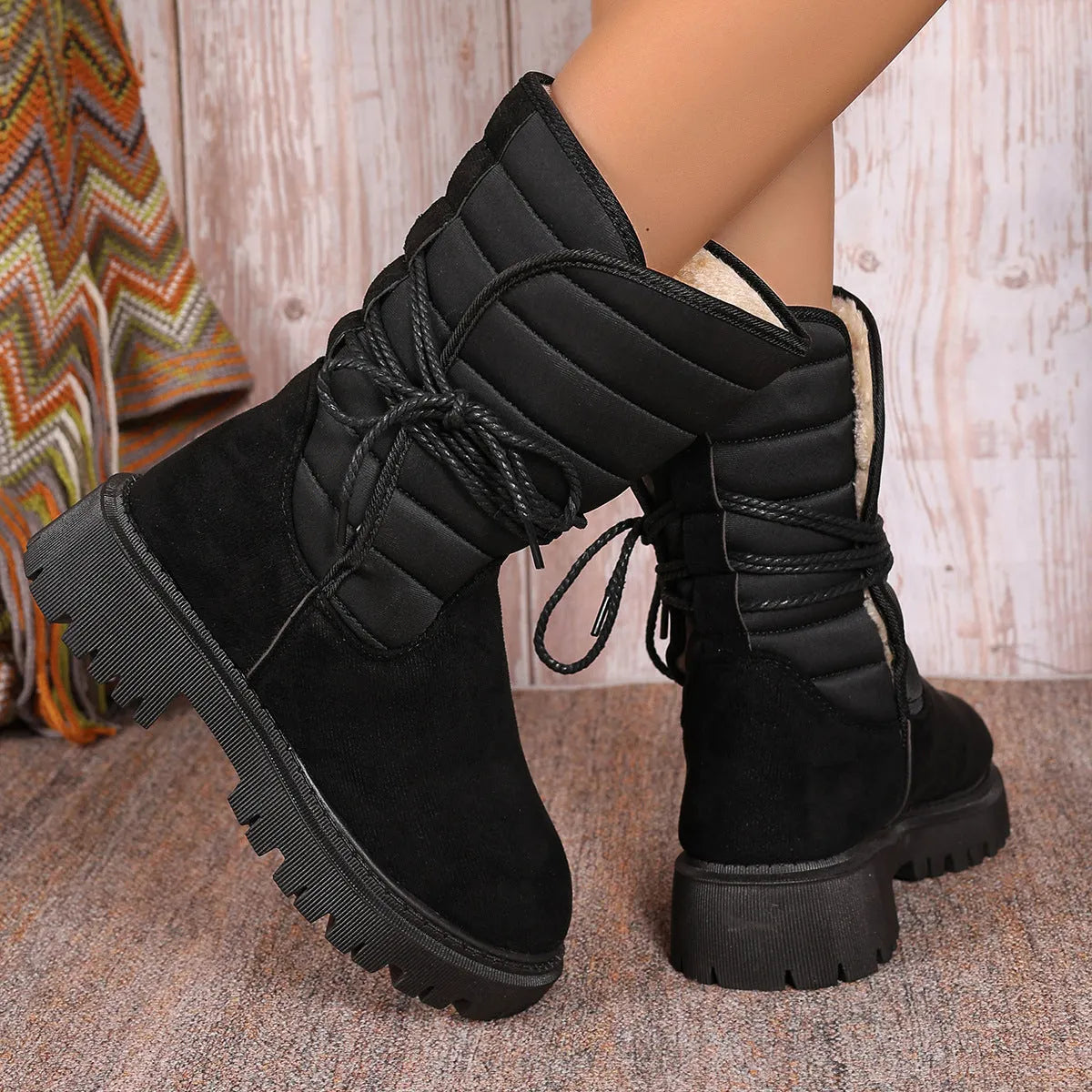 Women's black suede snow boots with chunky heel, lace-up design, and fleece lining