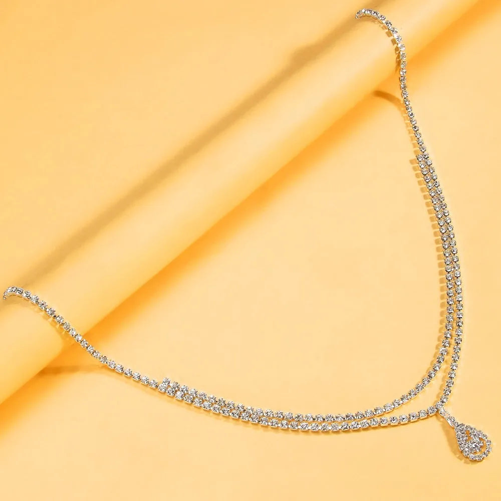 Gold or silver women's waist chain with water drop pendant measuring 115cm length with lobster buckle closure