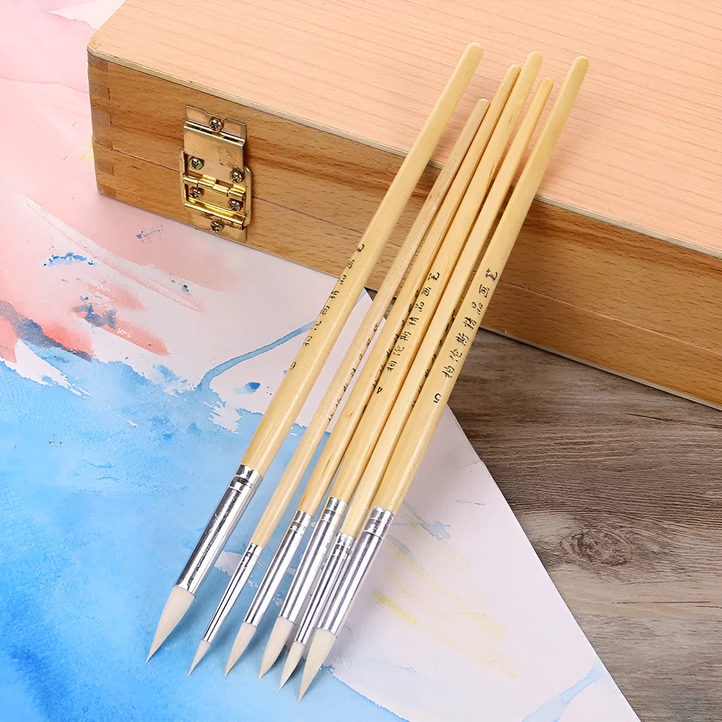 Six wooden pen brushes with pointed tips arranged together as an artistic brush set