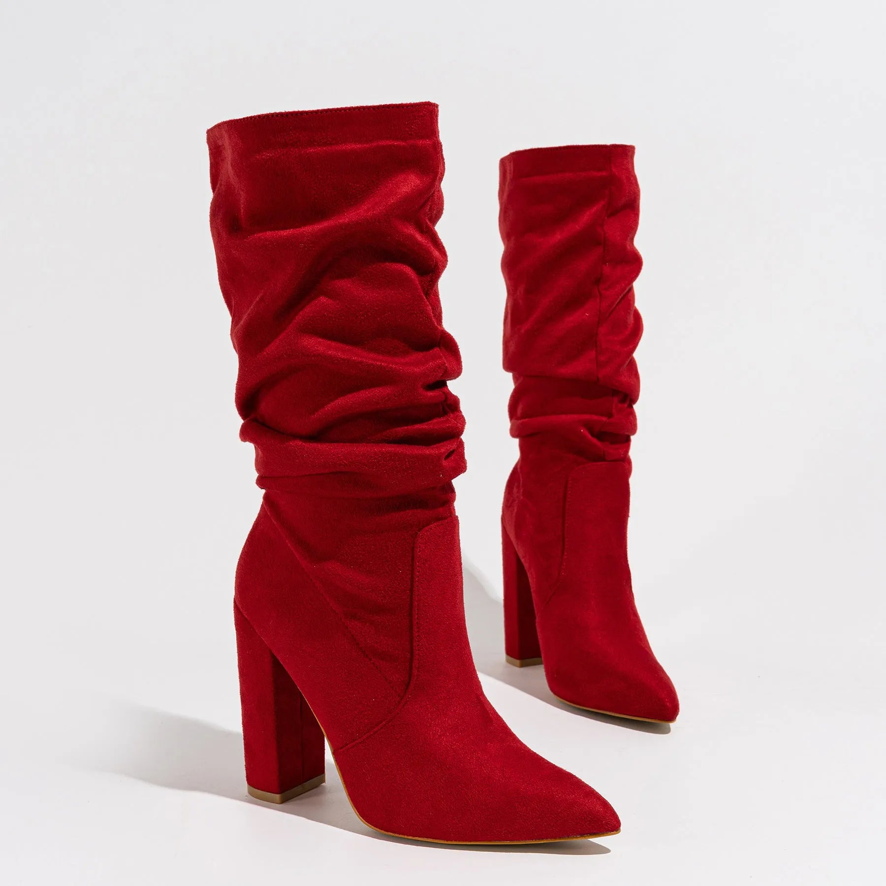 Women's black suede ankle boots with a high chunky heel and pointed toe.