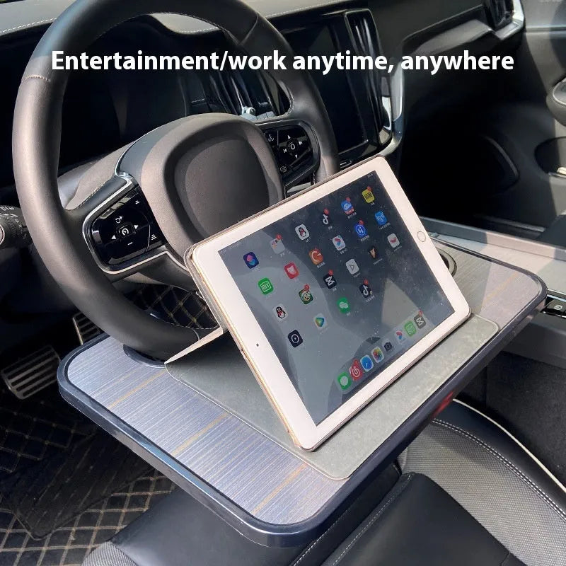 Black car steering wheel laptop stand tray with a foldable drink cup holder deployed.