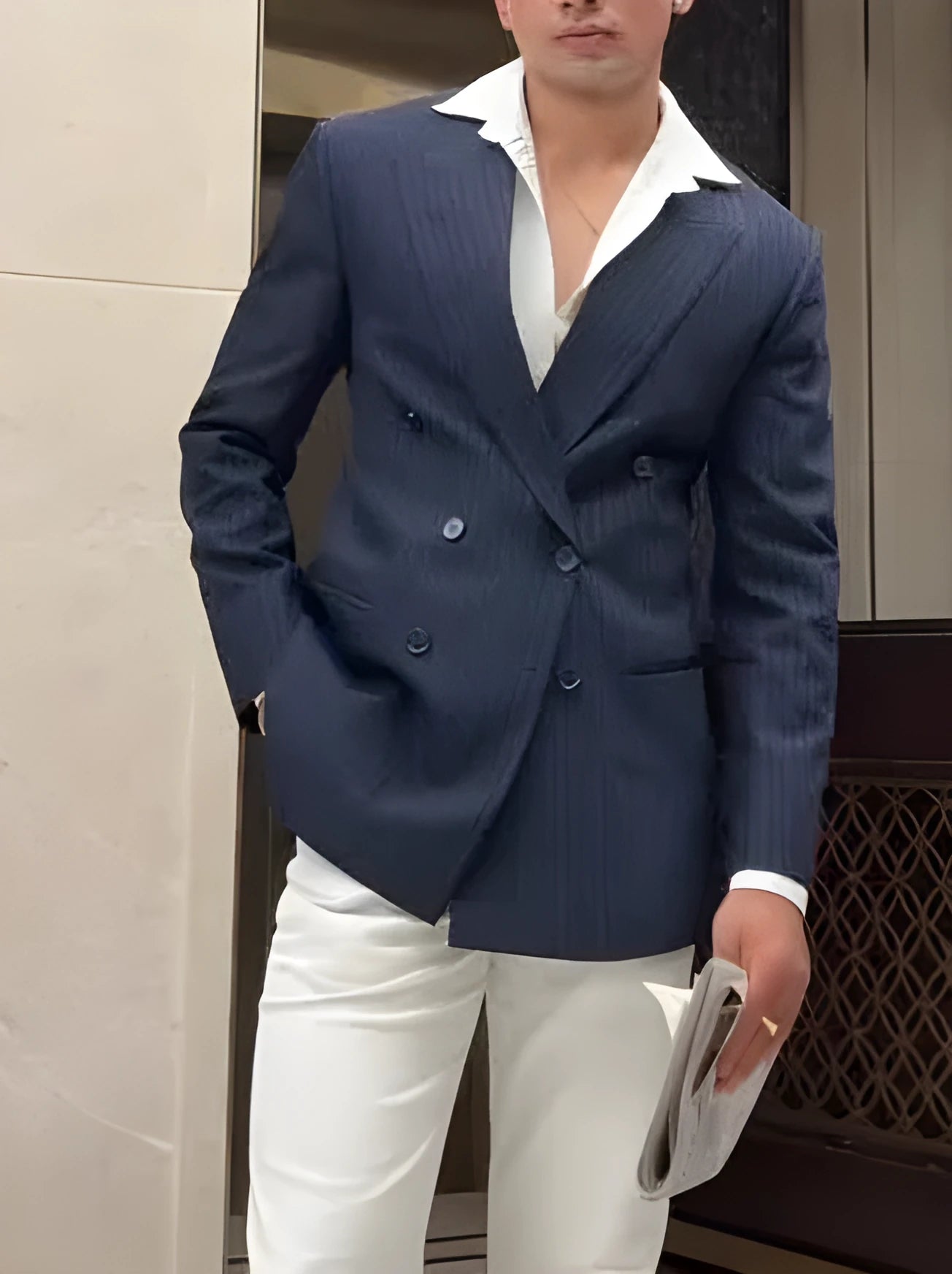 Men's striped double-breasted blazer on a hanger showing regular fit and length