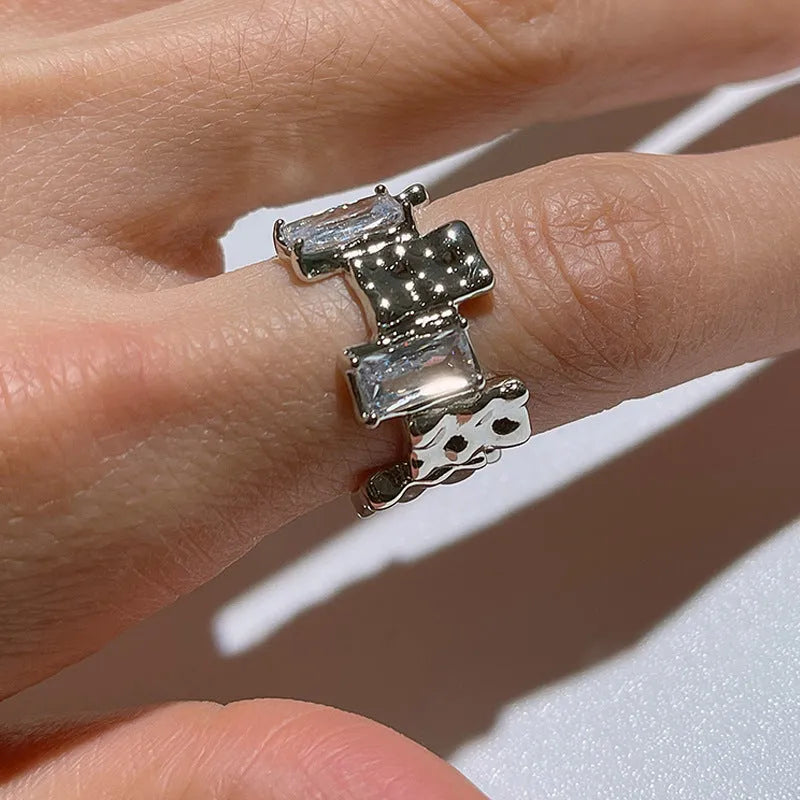 Silver geometric cross ring with open zircon gemstone design and three-dimensional decoration