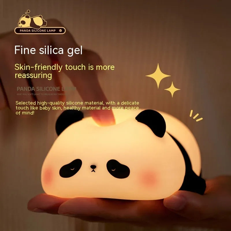 Panda shaped silicone night light with warm white glow on dark surface