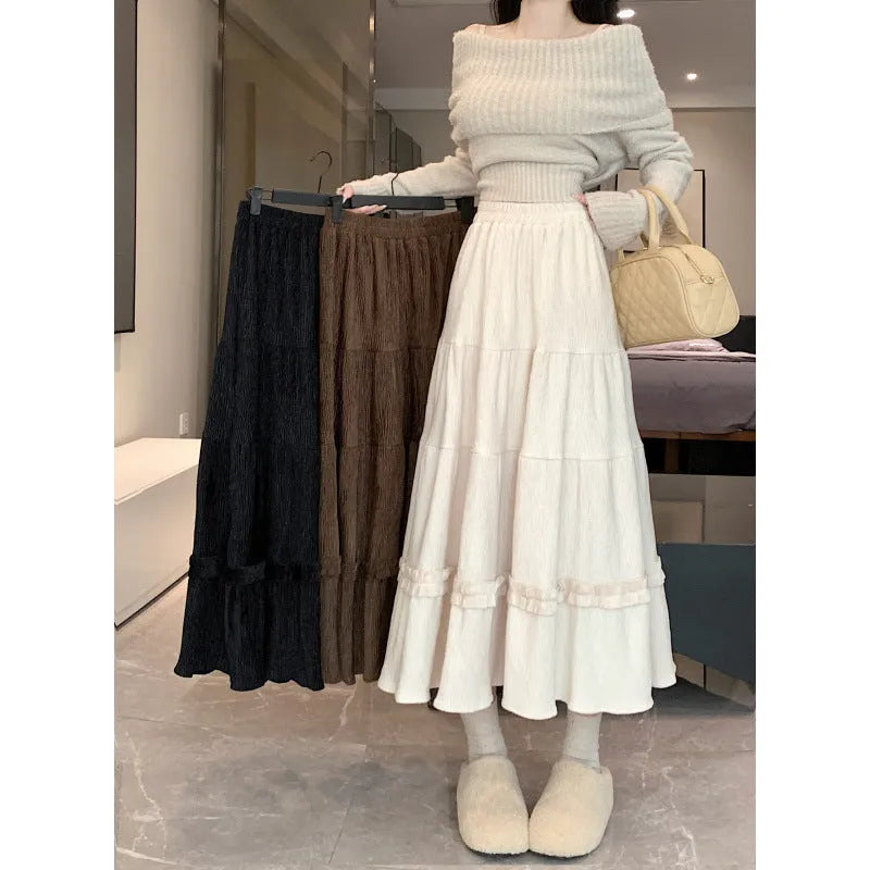 Korean style corduroy A-line midi skirt with an elastic waistband in a solid colour.
