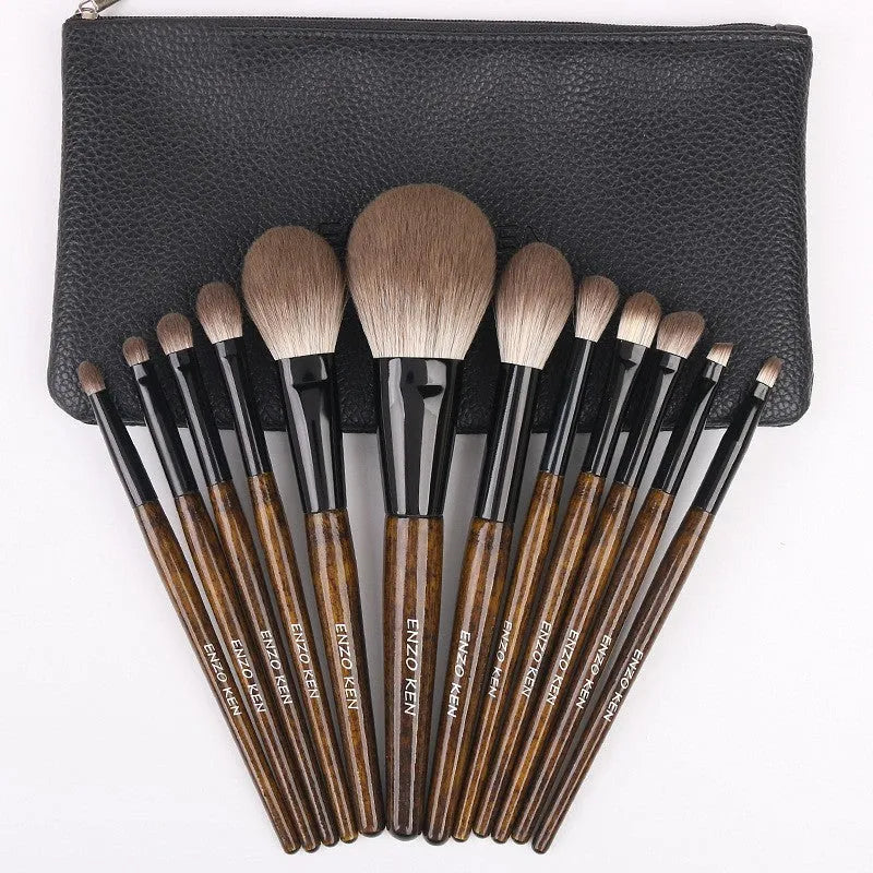 12-piece makeup brush set with wooden handles and a black PU storage pouch laid out.