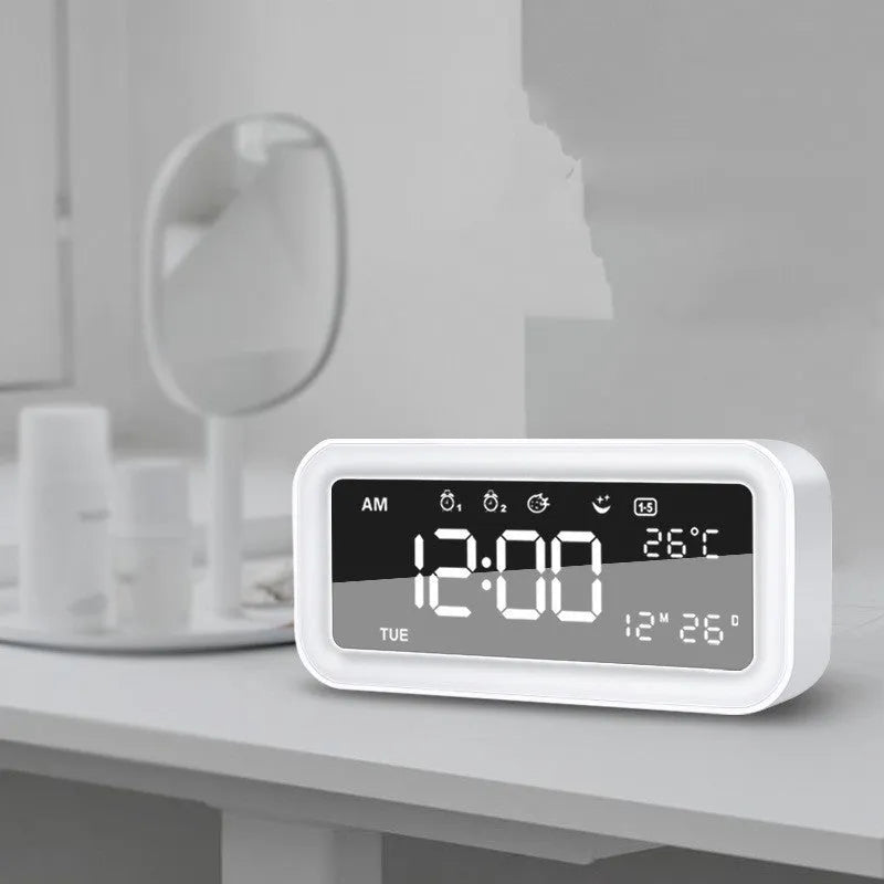 Blue rectangular LED alarm clock with atmosphere lighting on a wooden desk.
