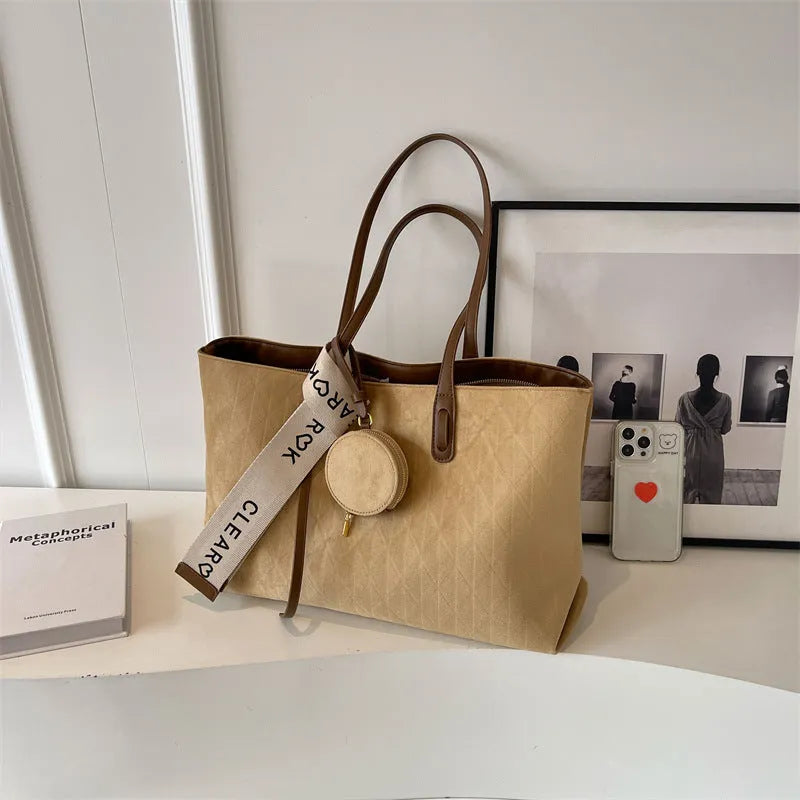 Soft polyester large tote shoulder bag in a horizontal square shape with an external pocket.