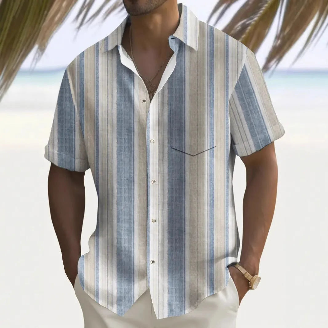 Man wearing a loose-fitting, multicolour printed cardigan-style polyester shirt.