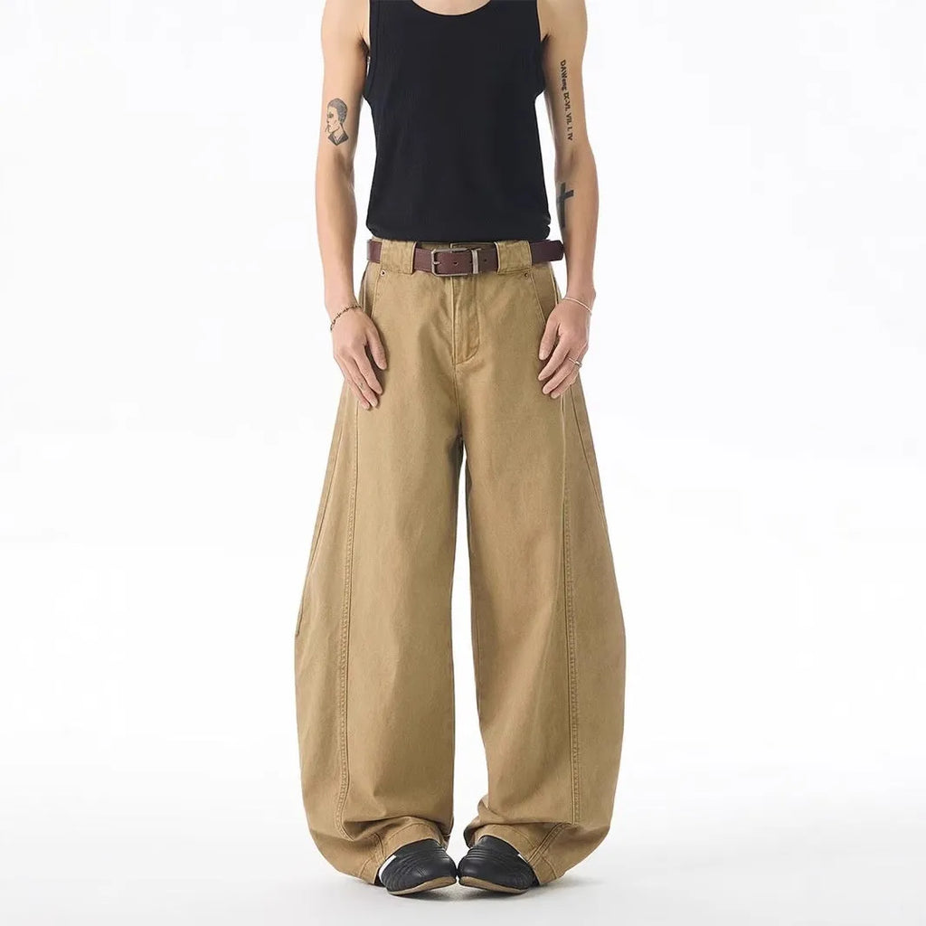 Brown loose-fit men's denim jeans with a straight leg and button fly on a neutral background.
