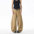 Brown loose-fit men's denim jeans with a straight leg and button fly on a neutral background.