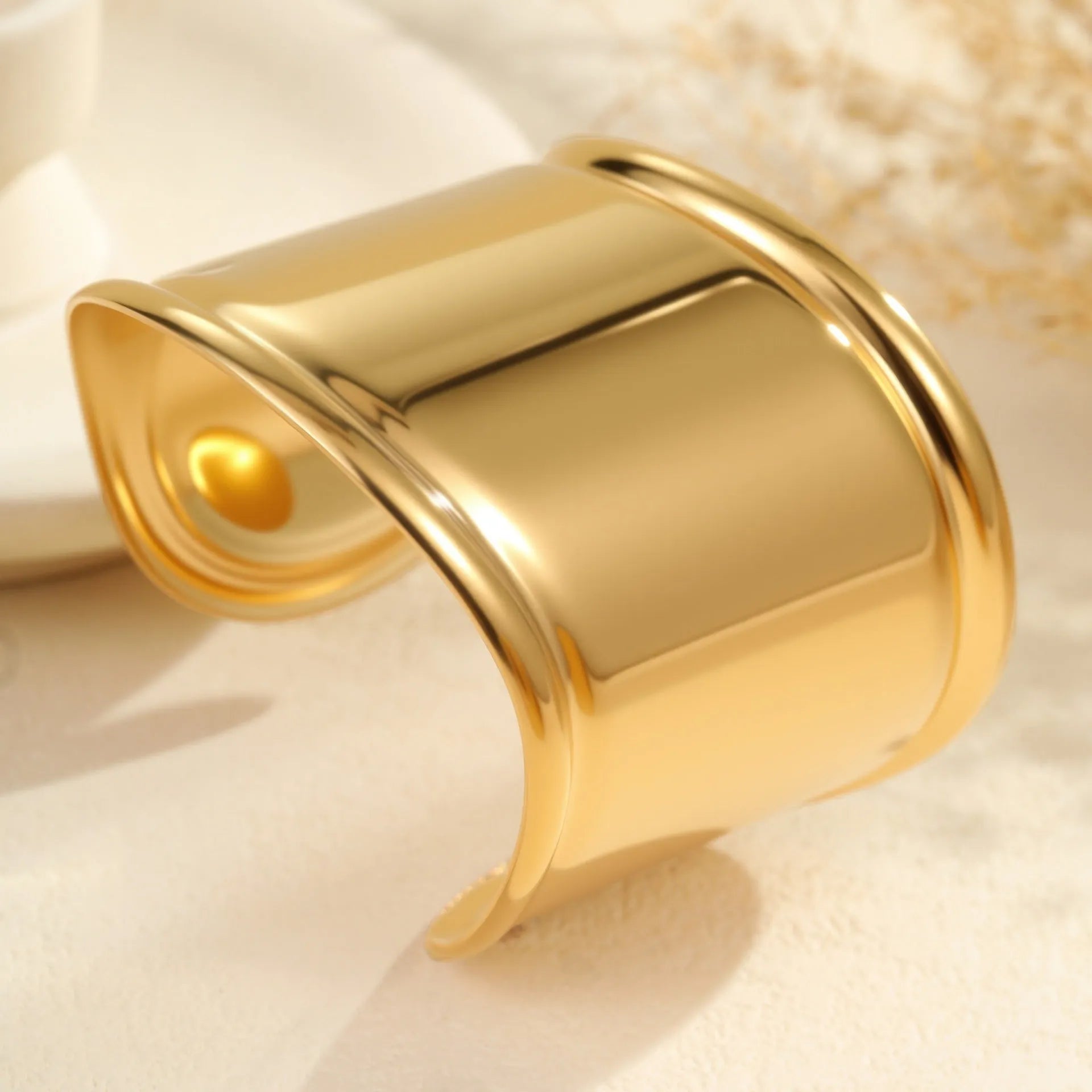 Women's wide cuff bracelet with gold plating and exaggerated niche opening in asymmetric wave design