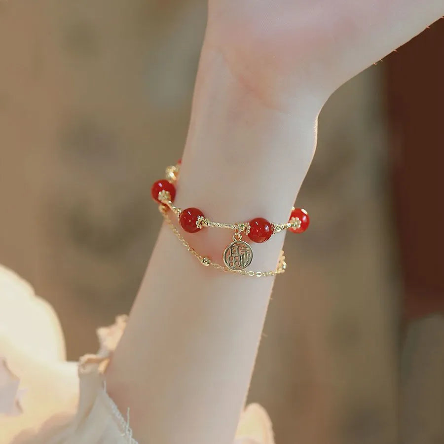 Red agate blessing card double-layer bracelet on display with alloy electroplated finish and chamfered square pattern