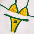 Women's yellow T-back bikini set with shorts-length bottoms laid flat.
