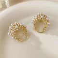 Gold-coloured women's flower basket earrings made from copper with small rice-shaped beads.