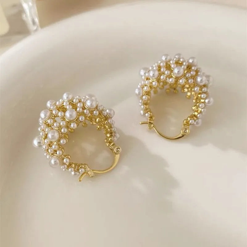 Gold-coloured women's flower basket earrings made from copper with small rice-shaped beads.