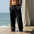 Man wearing loose fit solid colour cotton casual trousers in a leisure setting.