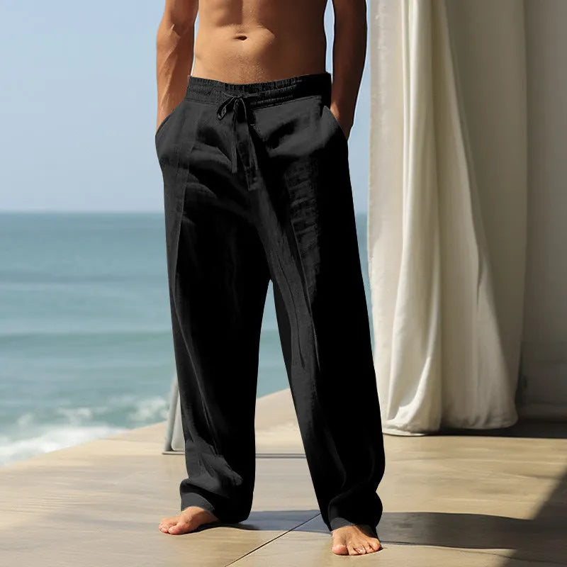 Man wearing loose fit solid colour cotton casual trousers in a leisure setting.