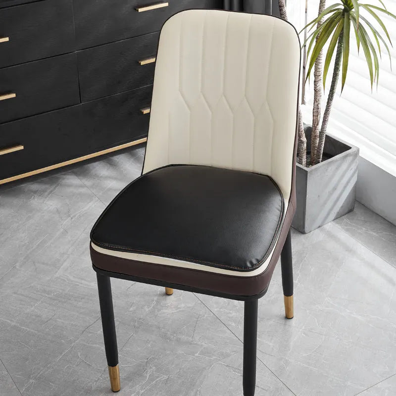 Brown leather horseshoe-shaped seat cushion with non-slip backing on a wooden chair.