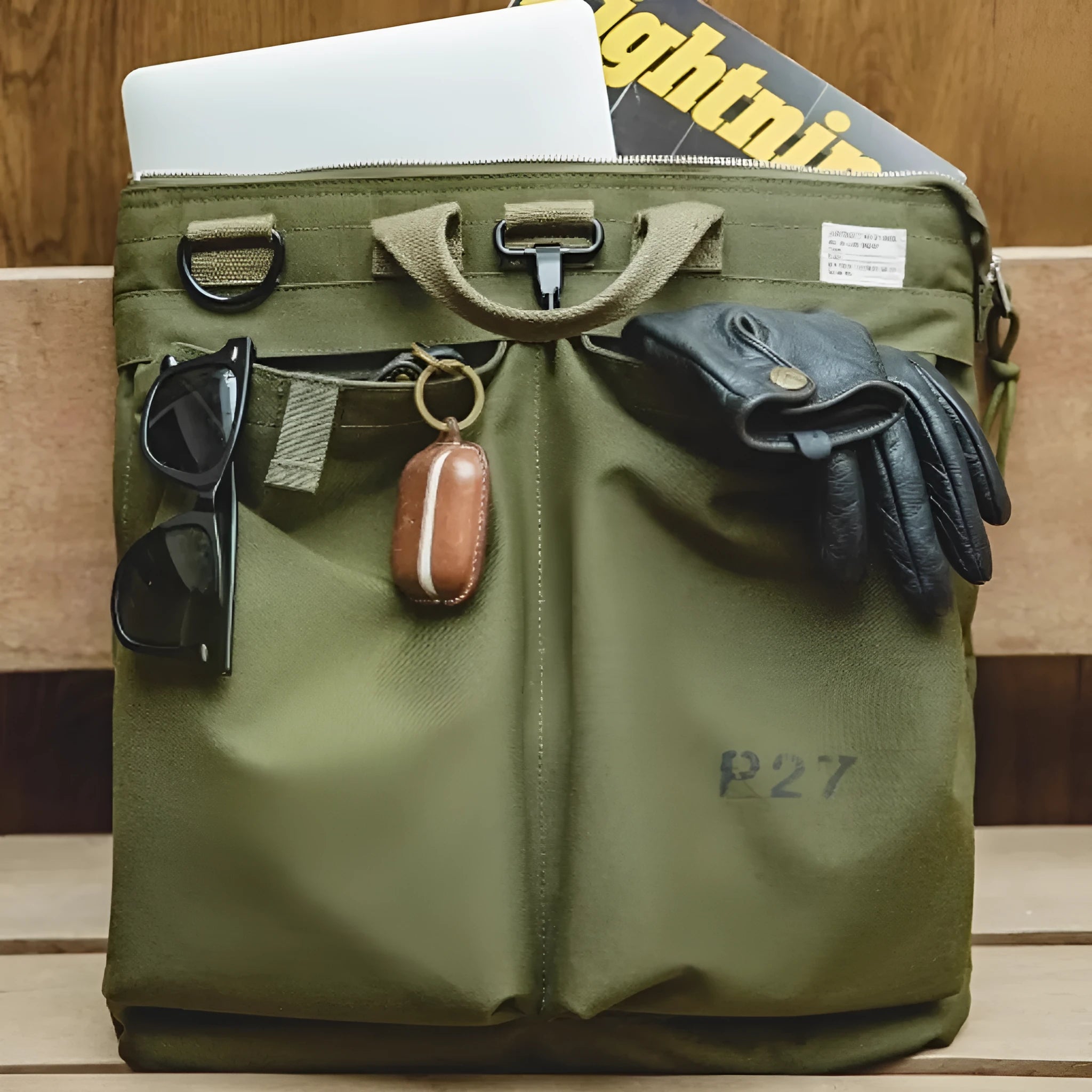 Marden Tooling military green canvas messenger bag with crossbody strap on a table