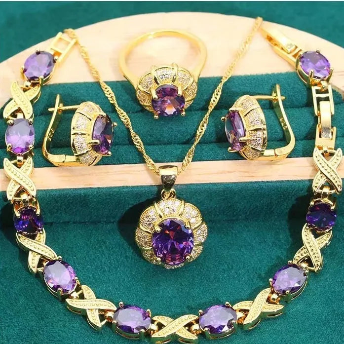 Gold-plated necklace, earrings, ring and bracelet set with blue cubic zirconia stones.