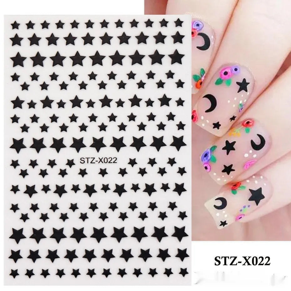 Close-up of a cartoon-style nail sticker with black and silver strips and a love pattern design on a fingernail.