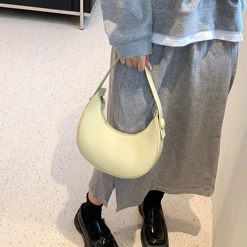 Women's cream yellow retro dumpling-shaped PU leather shoulder bag showing front and internal zippered pocket.