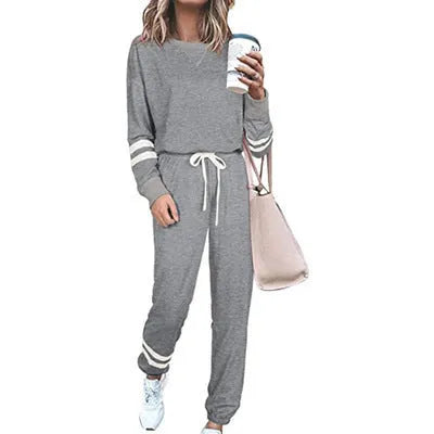 Women's loose-fitting casual suit set in a solid colour, comprising a long-sleeve top and matching trousers.