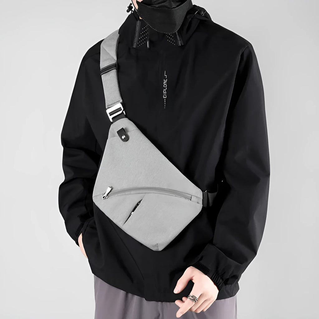 Men's black Oxford cloth chest bag worn across shoulder with letter detail